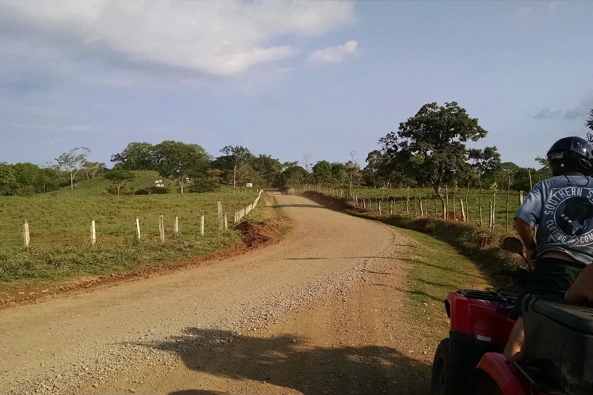 Guided ATV riders along a forested mountain ridge in Costa Rica