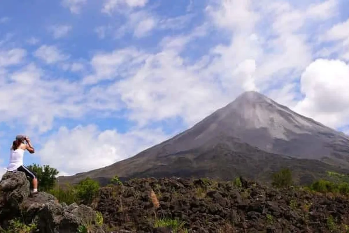 Arenal Volcano rising above lush rainforest in La Fortuna, Costa Rica